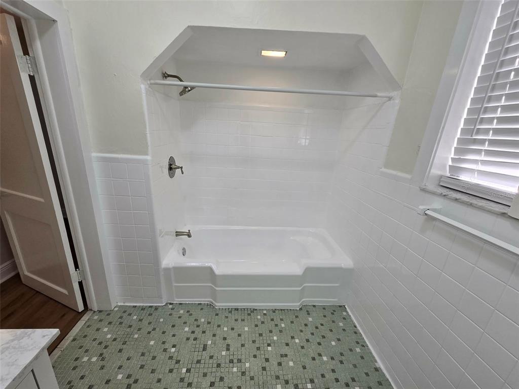 3301 West Woodlawn Avenue Tampa, FL 33607 - Photo 13 of 39 a bathroom with a sink and a shower