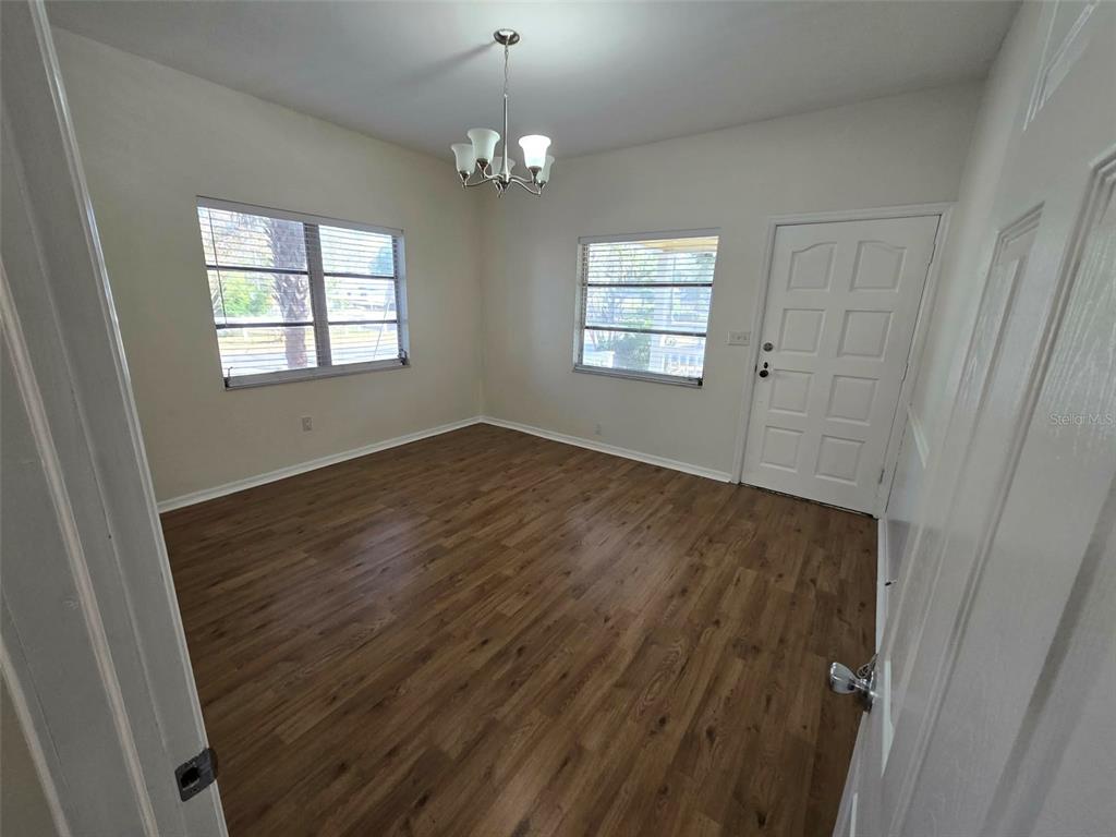 3301 West Woodlawn Avenue Tampa, FL 33607 - Photo 16 of 39 a view of an empty room with wooden floor and a window