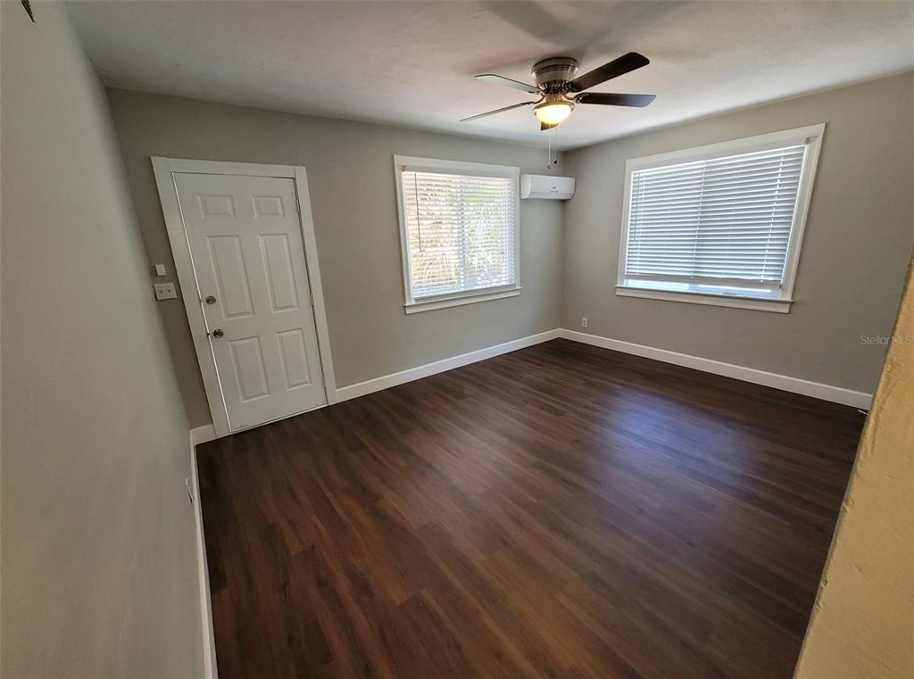 3301 West Woodlawn Avenue Tampa, FL 33607 - Photo 23 of 39 a view of an empty room with wooden floor and a window