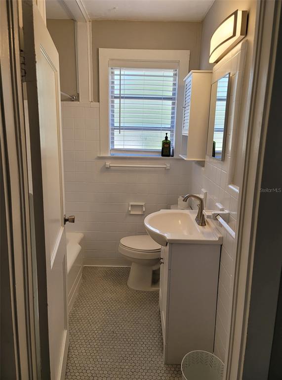 3301 West Woodlawn Avenue Tampa, FL 33607 - Photo 24 of 39 a bathroom with a sink a toilet and a mirror