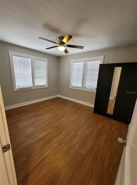 3301 West Woodlawn Avenue Tampa, FL 33607 - Photo 27 of 39 wooden floor in an empty room with a window