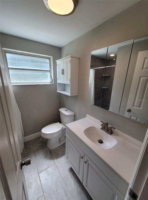 3301 West Woodlawn Avenue Tampa, FL 33607 - Photo 31 of 39 a bathroom with a sink toilet and mirror