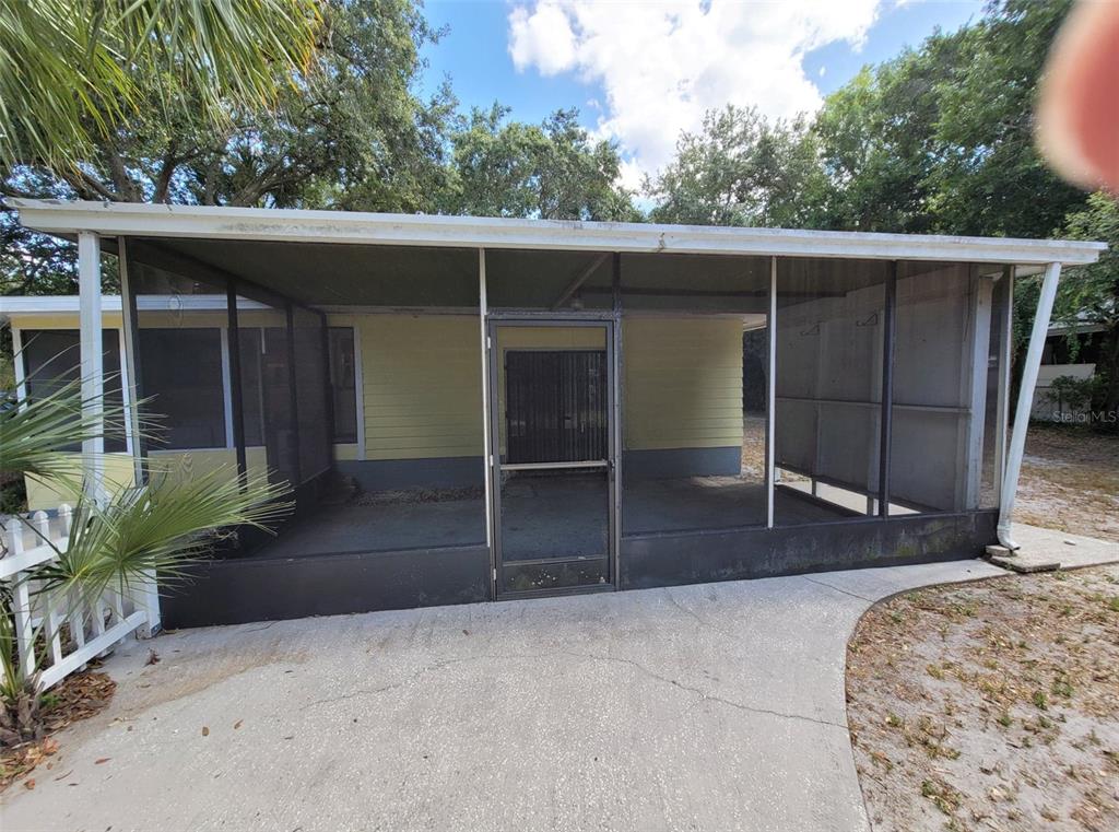 3301 West Woodlawn Avenue Tampa, FL 33607 - Photo 6 of 39 a view of backyard with cabin and wooden fence