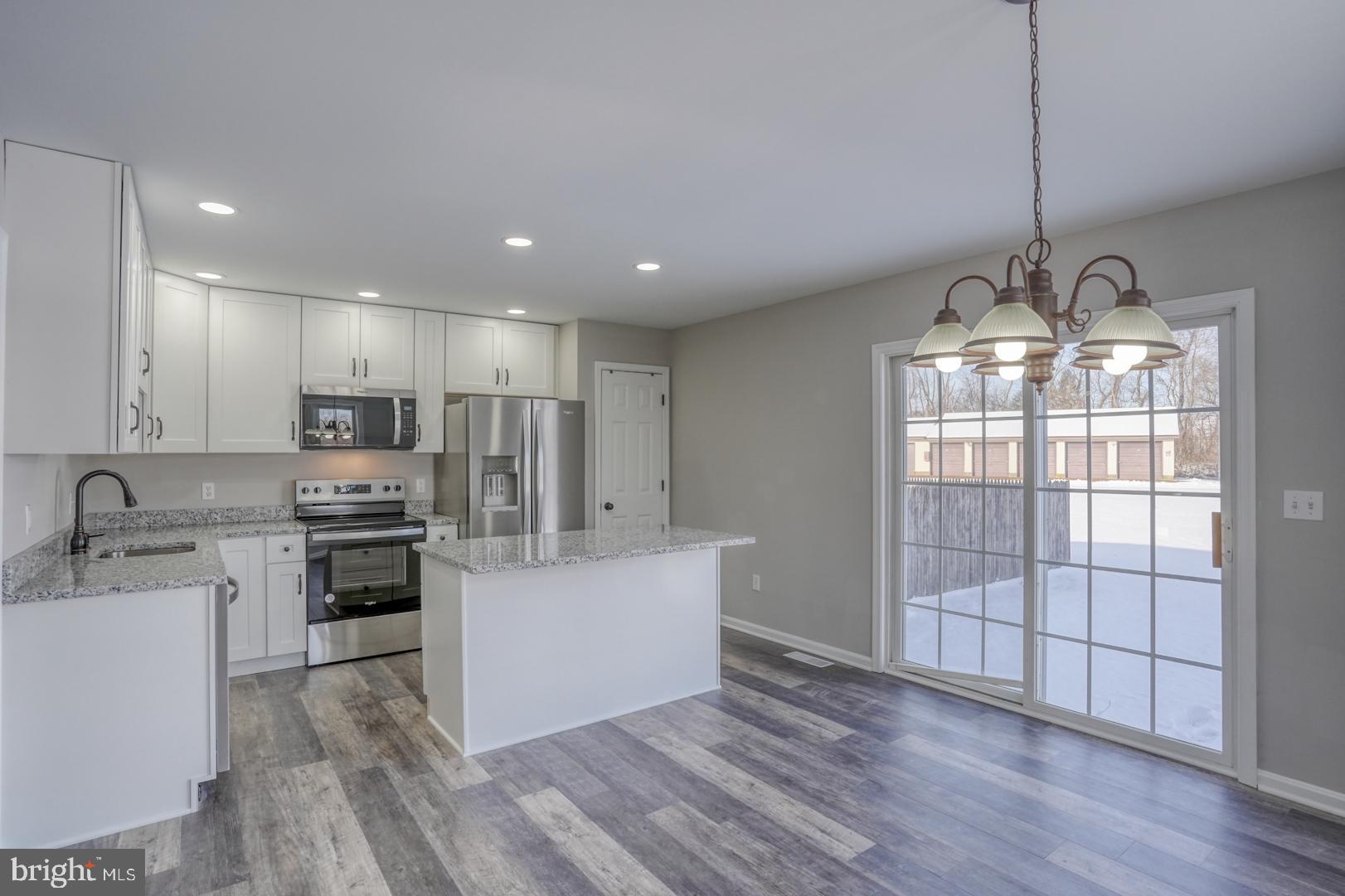 39 High Street Kenton, DE 19955 - Photo 19 of 49 a view of a kitchen with stainless steel appliances granite countertop a stove and a sink