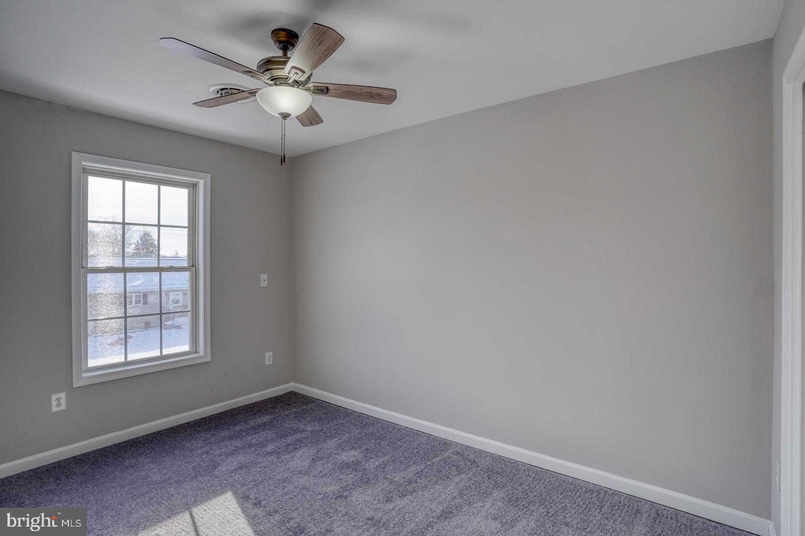 39 High Street Kenton, DE 19955 - Photo 25 of 49 an empty room with windows and fan
