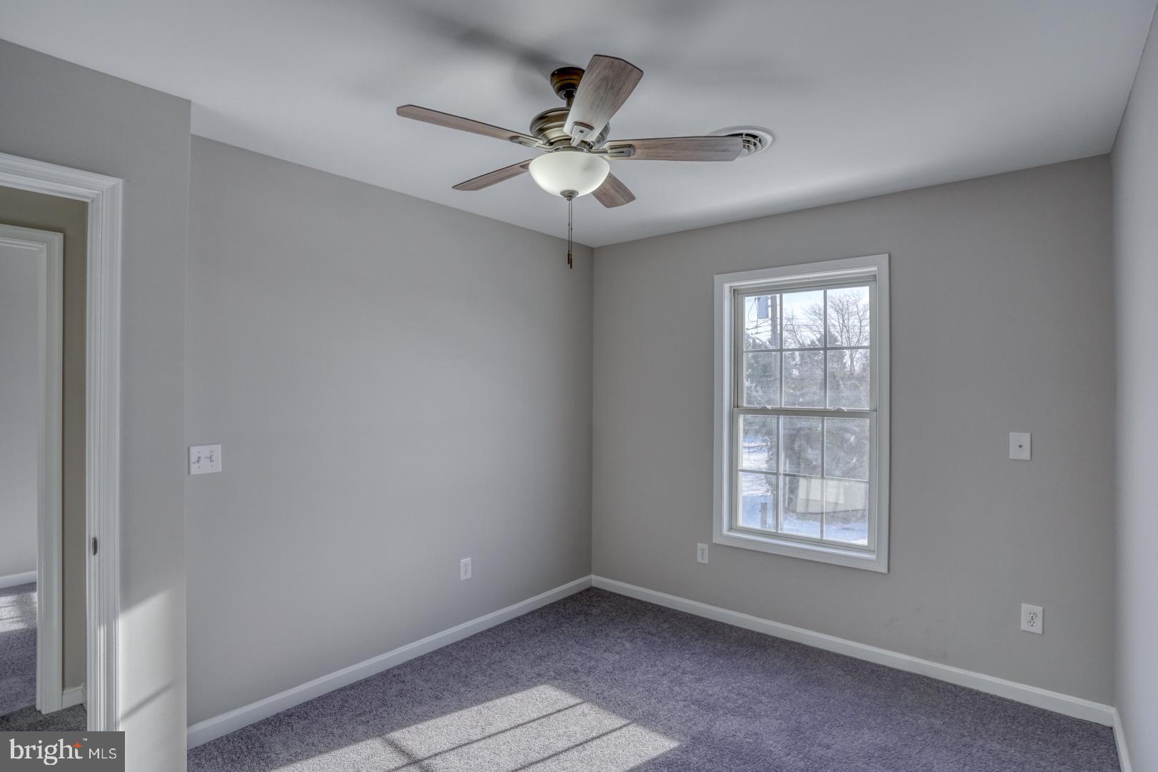 39 High Street Kenton, DE 19955 - Photo 26 of 49 an empty room with windows and ceiling fan