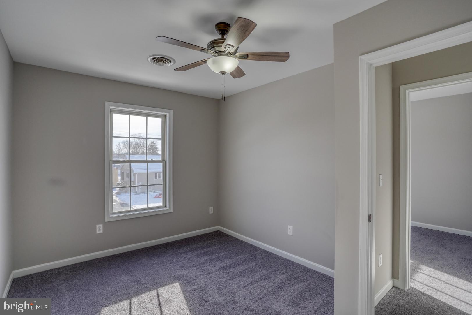 39 High Street Kenton, DE 19955 - Photo 28 of 49 an empty room with windows and fan