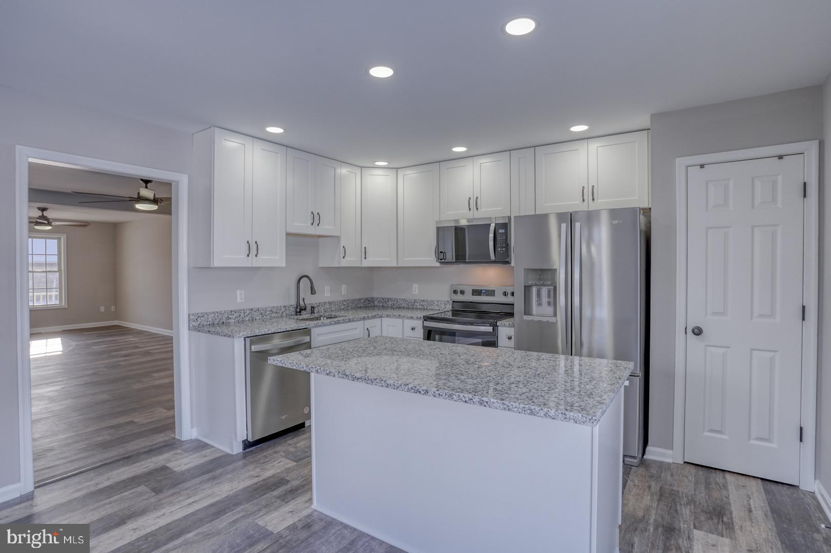 39 High Street Kenton, DE 19955 - Photo 29 of 49 a kitchen with stainless steel appliances granite countertop a sink a stove a refrigerator and cabinets