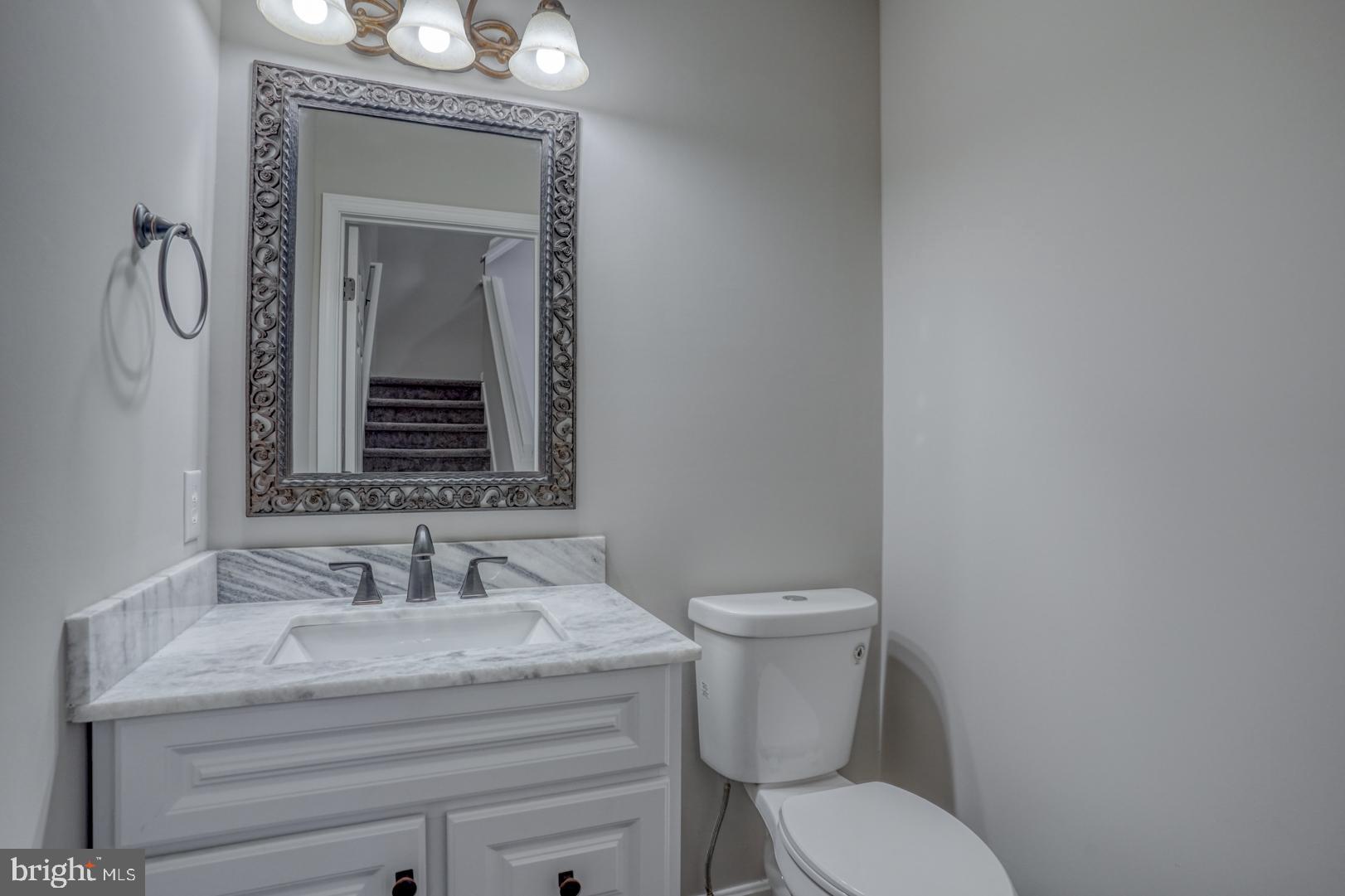 39 High Street Kenton, DE 19955 - Photo 35 of 49 a bathroom with a toilet a sink and mirror