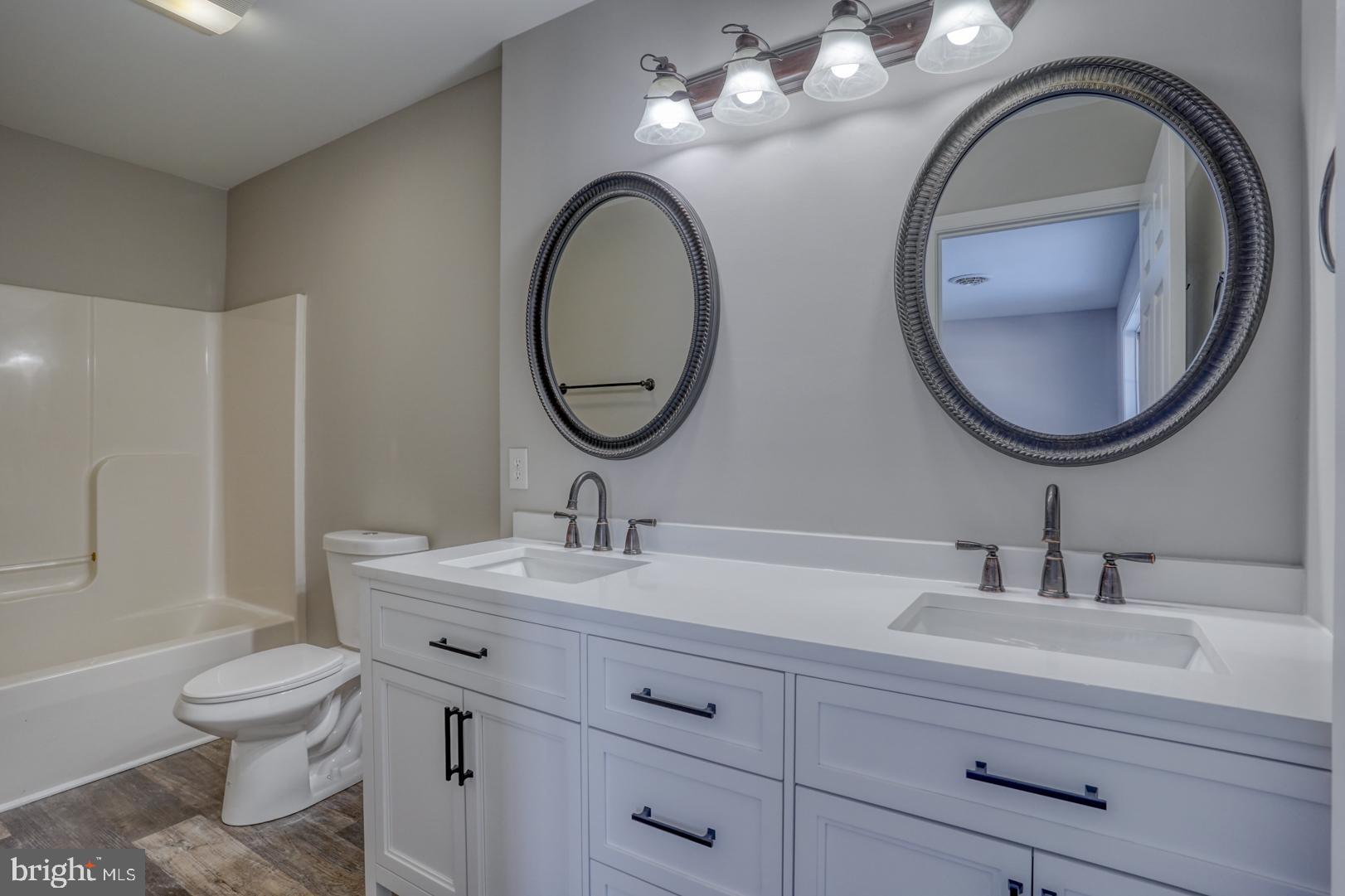 39 High Street Kenton, DE 19955 - Photo 40 of 49 a bathroom with a toilet a sink and a mirror