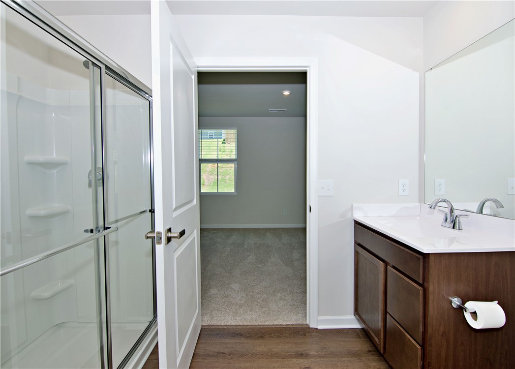 723 Peridot Way Westminster, SC 29693 - Photo 23 of 45 A sleek, contemporary bathroom offers a functional vanity and a clear glass-enclosed shower.