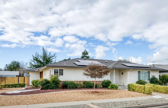 a front view of a house with a garden