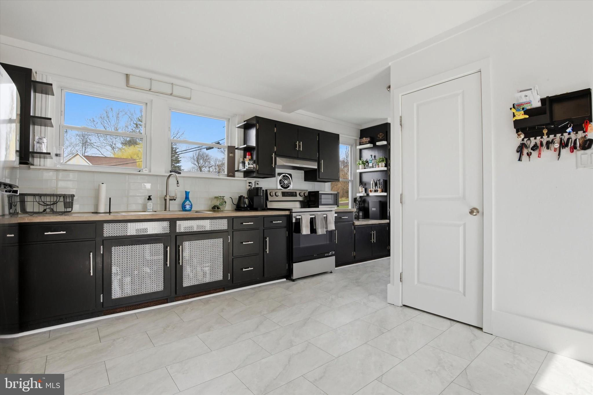 429 Main Street Green Lane, PA 18054 - Photo 5 of 25 a large kitchen with cabinets and stainless steel appliances