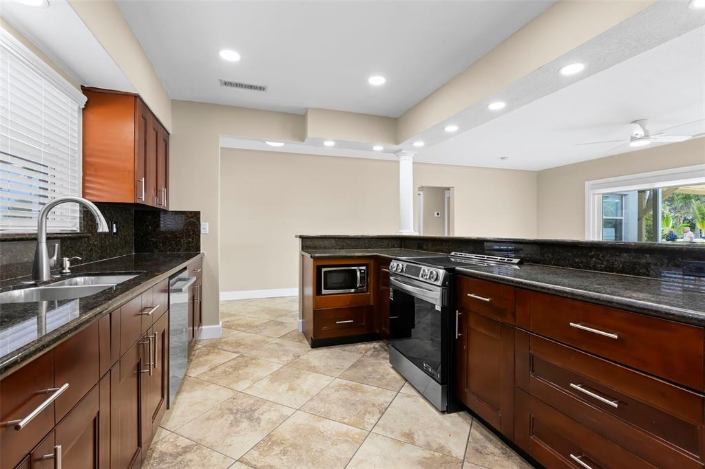 708 Sunset Cove Madeira Beach, FL 33708 - Photo 9 of 61 a large kitchen with stainless steel appliances and large counter space