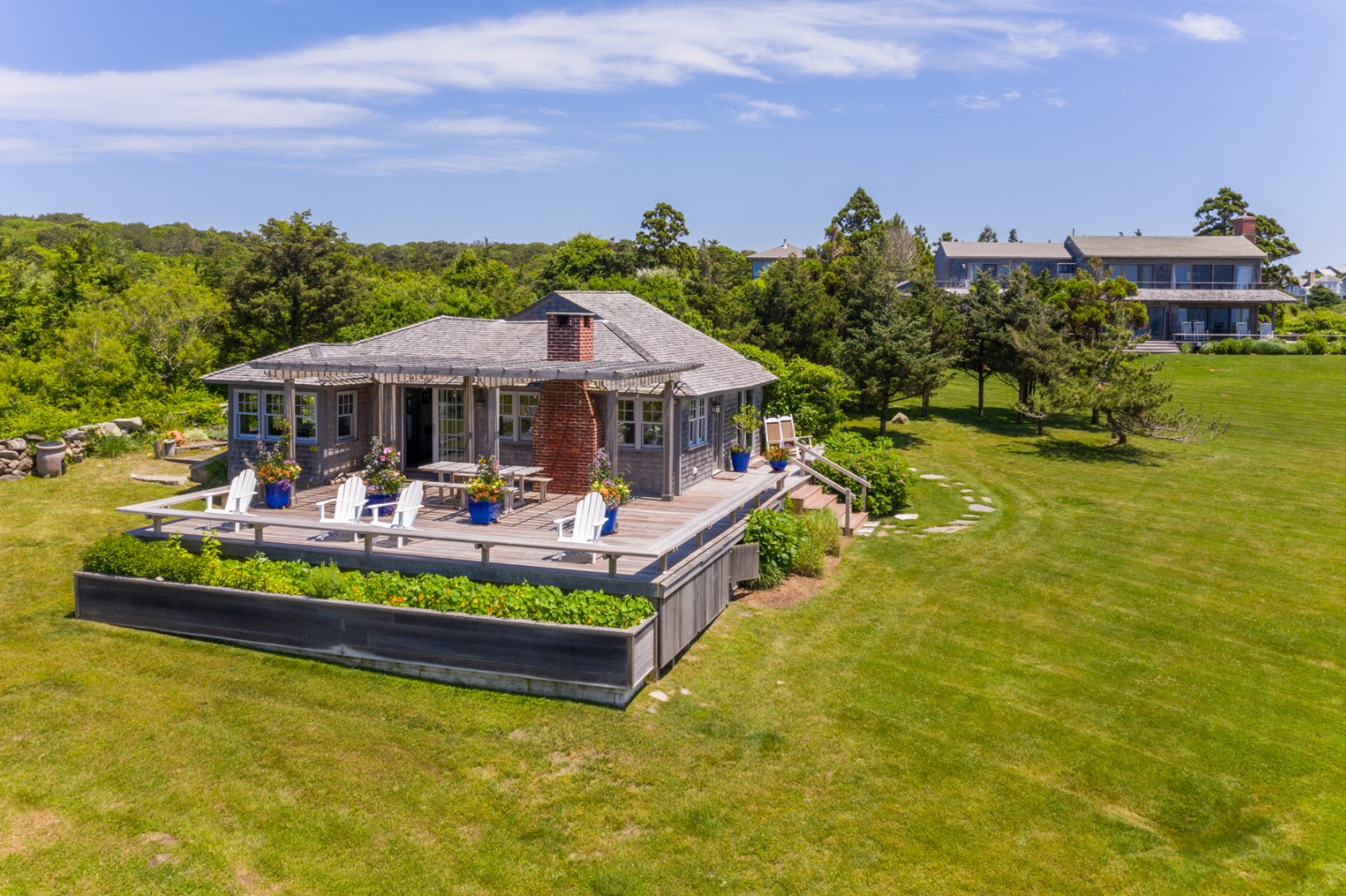 95 Stonewall Road Chilmark, MA 02535 - Photo 22 of 51 a view of a swimming pool with lounge chair in front of house