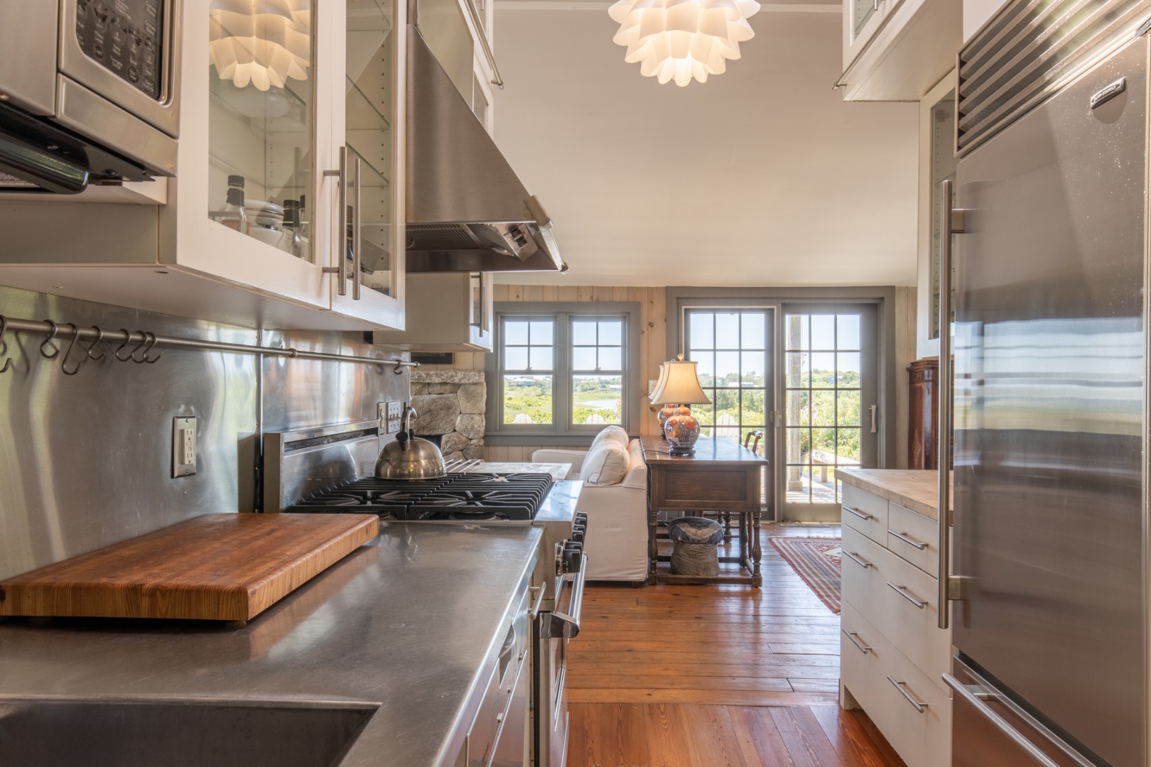 95 Stonewall Road Chilmark, MA 02535 - Photo 28 of 51 a view of a kitchen with kitchen island a large window a sink and stainless steel appliances