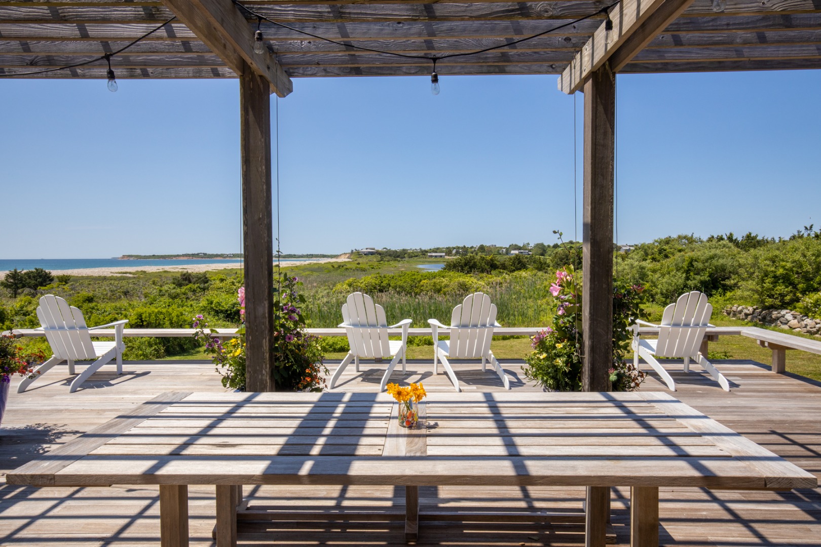 95 Stonewall Road Chilmark, MA 02535 - Photo 36 of 51 a view of a patio with lawn chairs wooden floor and outdoor seating