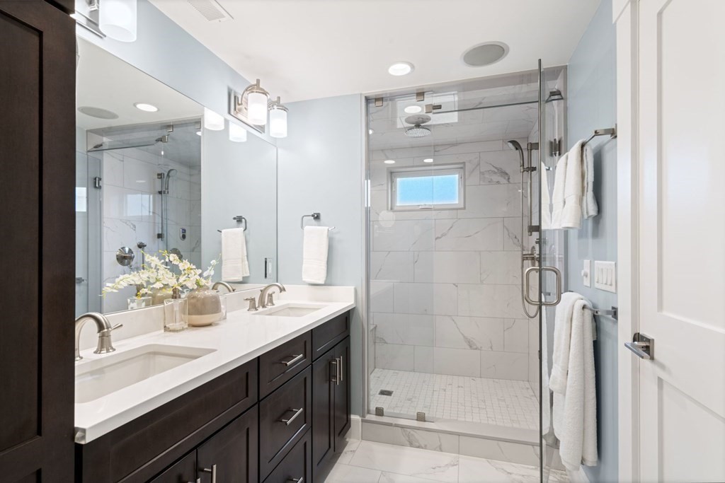 8 Clyde Street Somerville, MA 02145 - Photo 12 of 22 a bathroom with a shower sink vanity and mirror