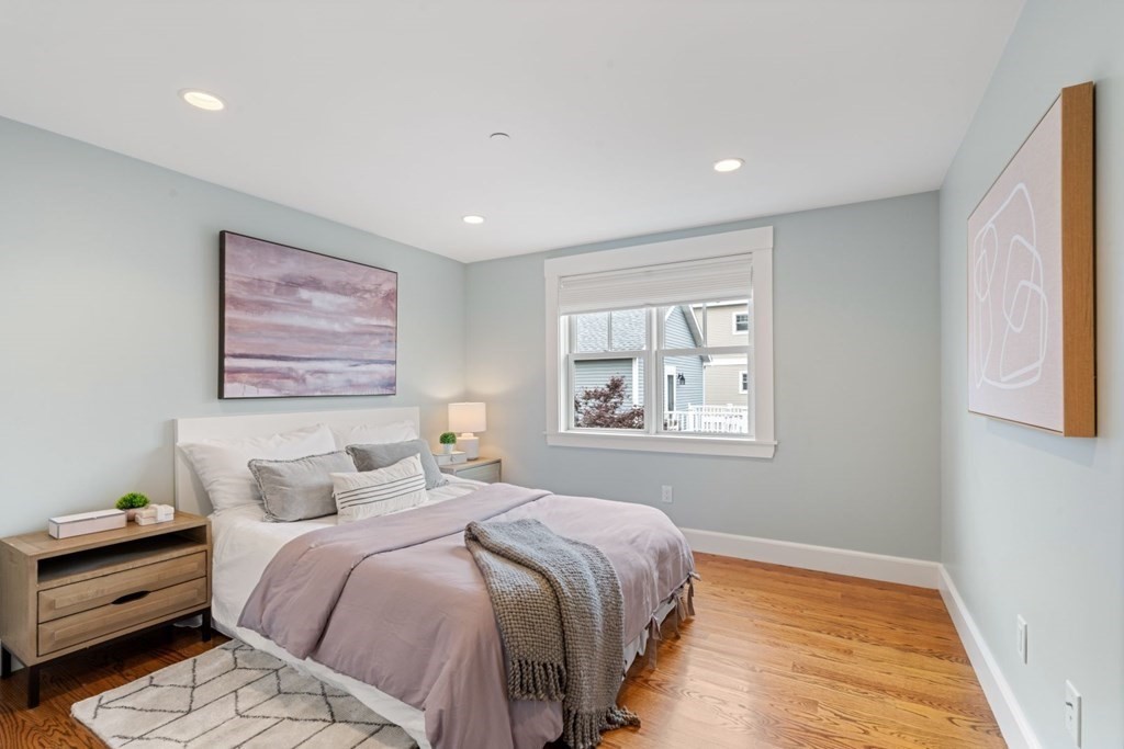 8 Clyde Street Somerville, MA 02145 - Photo 14 of 22 a bedroom with a bed and a window