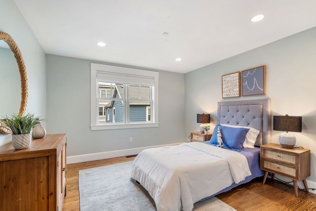 8 Clyde Street Somerville, MA 02145 - Photo 15 of 22 a bedroom with a large bed and a window