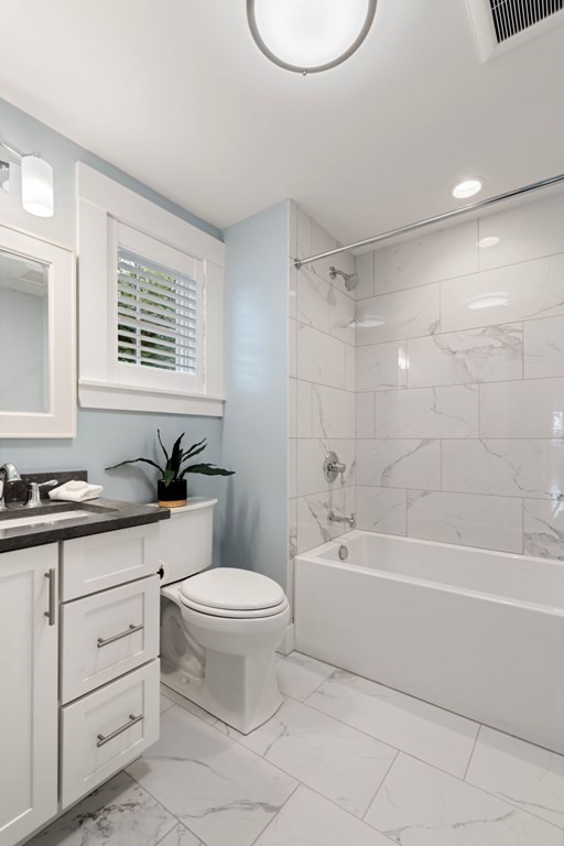 8 Clyde Street Somerville, MA 02145 - Photo 16 of 22 a bathroom with a granite countertop toilet a sink and bathtub