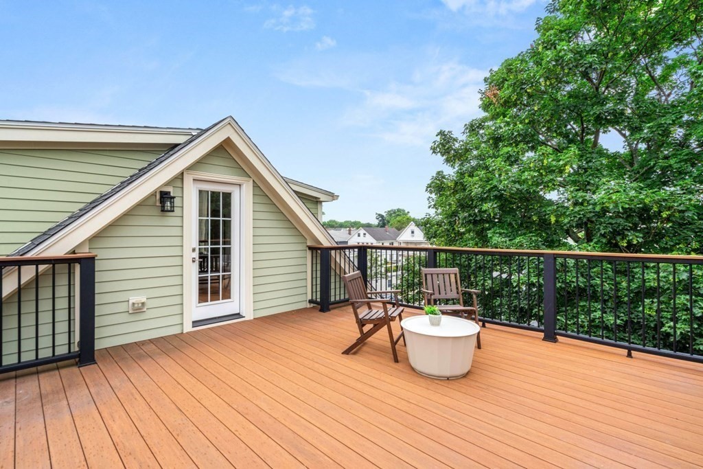 8 Clyde Street Somerville, MA 02145 - Photo 20 of 22 a view of a deck with furniture and wooden floor