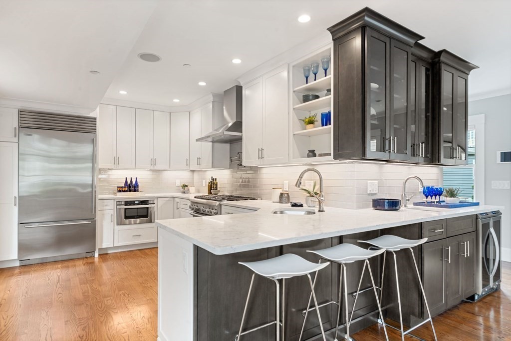 8 Clyde Street Somerville, MA 02145 - Photo 6 of 22 a kitchen with stainless steel appliances granite countertop a sink stove and refrigerator