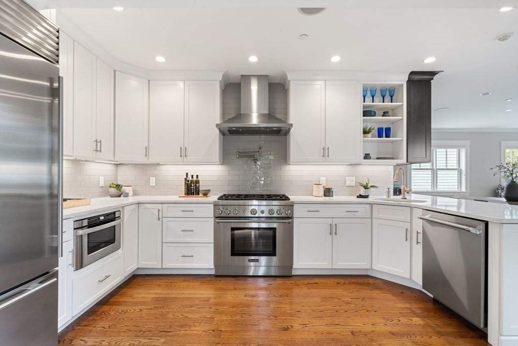 8 Clyde Street Somerville, MA 02145 - Photo 7 of 22 a kitchen with stainless steel appliances granite countertop a stove and a sink
