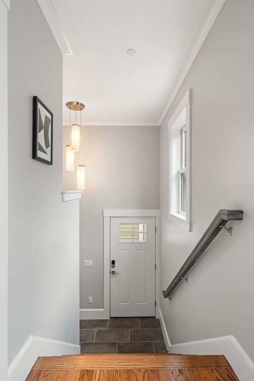 8 Clyde Street Somerville, MA 02145 - Photo 8 of 22 a view of a livingroom with wooden floor and staircase