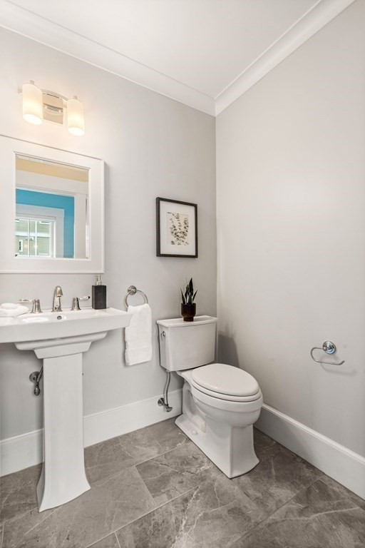 8 Clyde Street Somerville, MA 02145 - Photo 9 of 22 a bathroom with a toilet a sink and mirror