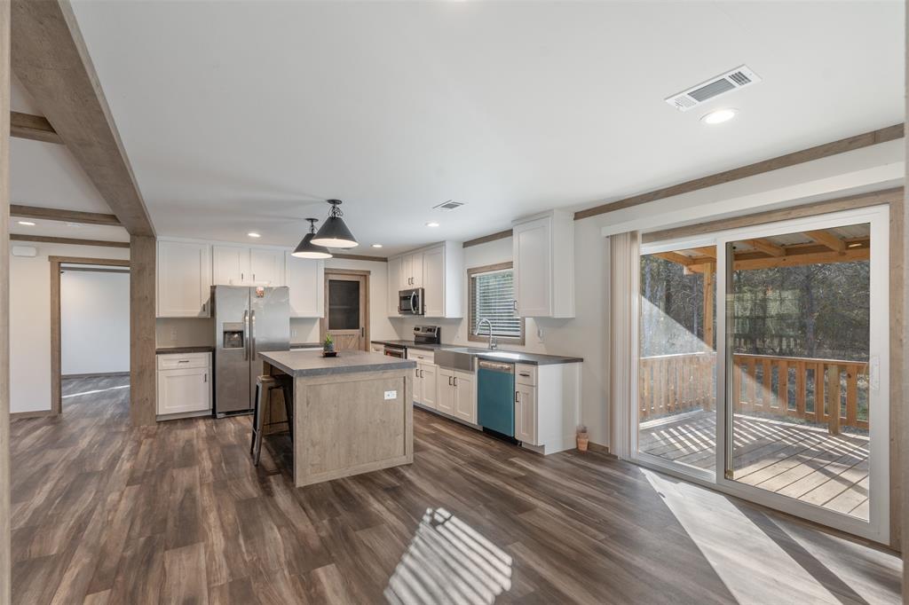 9603 County Road 2138 Kemp, TX 75143 - Photo 13 of 36 a open kitchen with sink cabinets and wooden floor