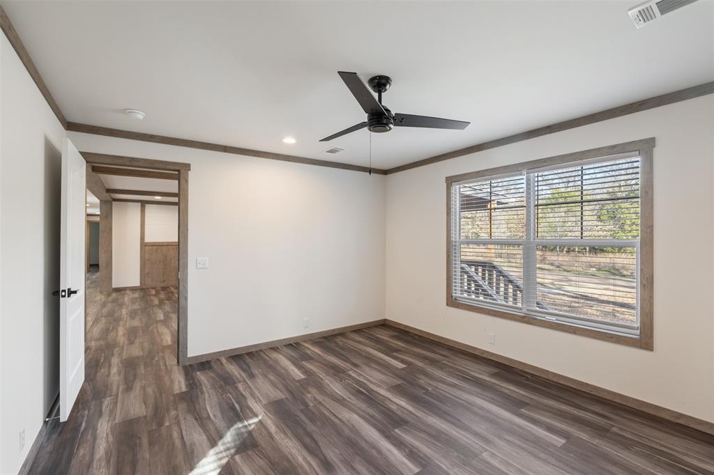 9603 County Road 2138 Kemp, TX 75143 - Photo 15 of 36 a view of empty room with wooden floor and fan