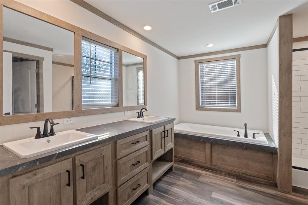 9603 County Road 2138 Kemp, TX 75143 - Photo 16 of 36 a spacious bathroom with a double vanity sink a mirror and a bathtub