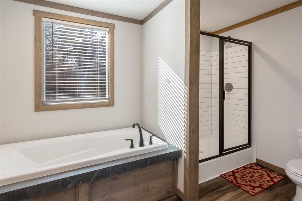 9603 County Road 2138 Kemp, TX 75143 - Photo 17 of 36 a bathroom with a bathtub and next to a window