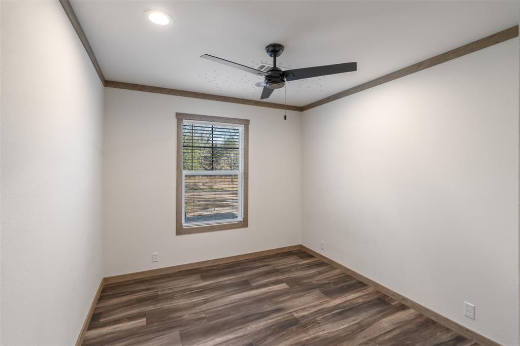9603 County Road 2138 Kemp, TX 75143 - Photo 20 of 36 an empty room with a window and ceiling fan