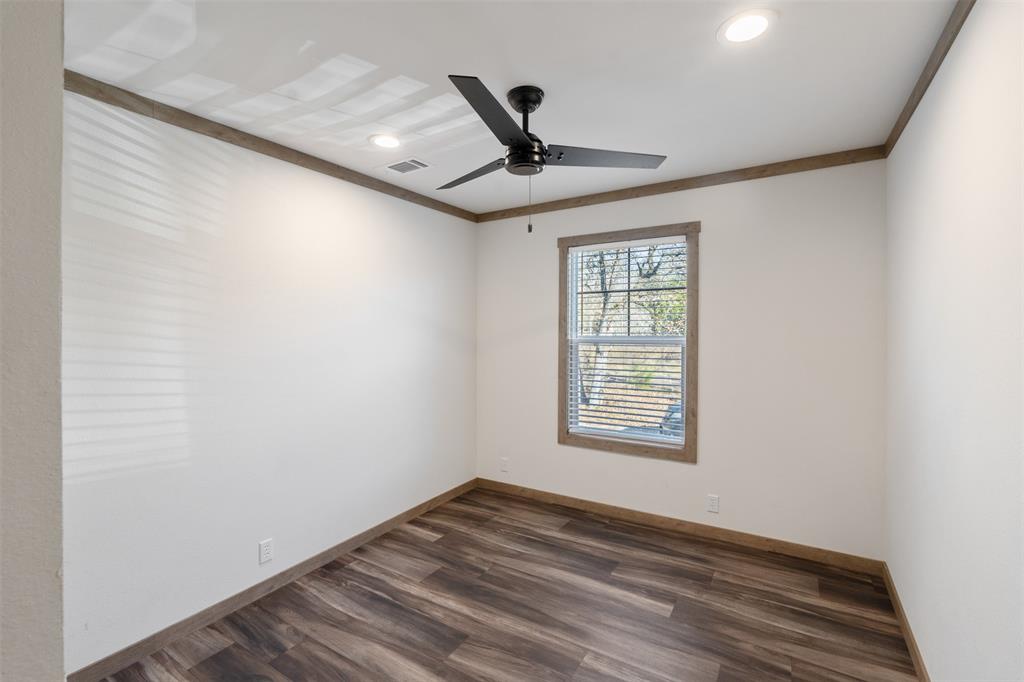 9603 County Road 2138 Kemp, TX 75143 - Photo 21 of 36 a view of an empty room with wooden floor and a window