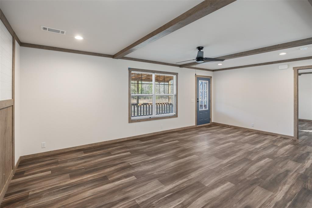 9603 County Road 2138 Kemp, TX 75143 - Photo 5 of 36 a view of an empty room with wooden floor and a window