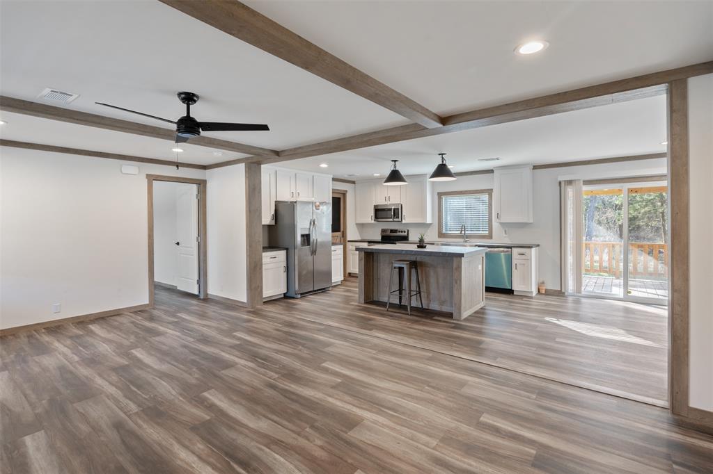 9603 County Road 2138 Kemp, TX 75143 - Photo 8 of 36 a view of a kitchen with stainless steel appliances wooden floor and a window