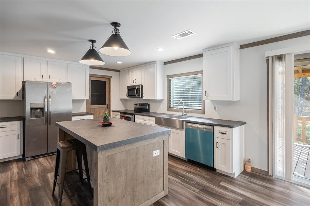 9603 County Road 2138 Kemp, TX 75143 - Photo 9 of 36 a kitchen with stainless steel appliances granite countertop a sink stove and refrigerator