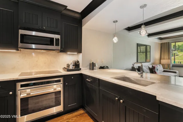 a kitchen with a sink stove and microwave