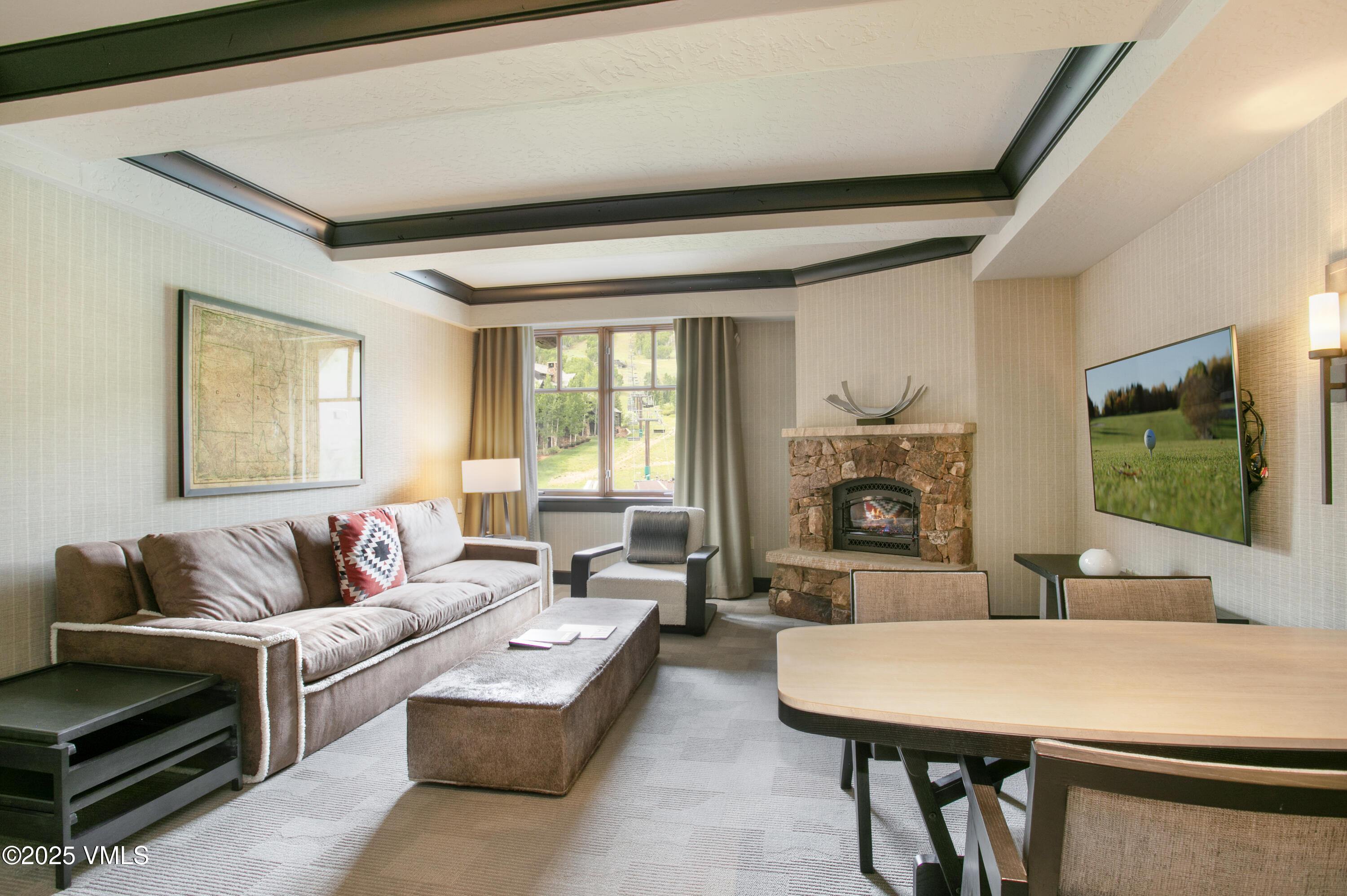 130 Daybreak Ridge Road, Unit 732 Avon, CO 81620 - Photo 2 of 17 a living room with furniture and a flat screen tv