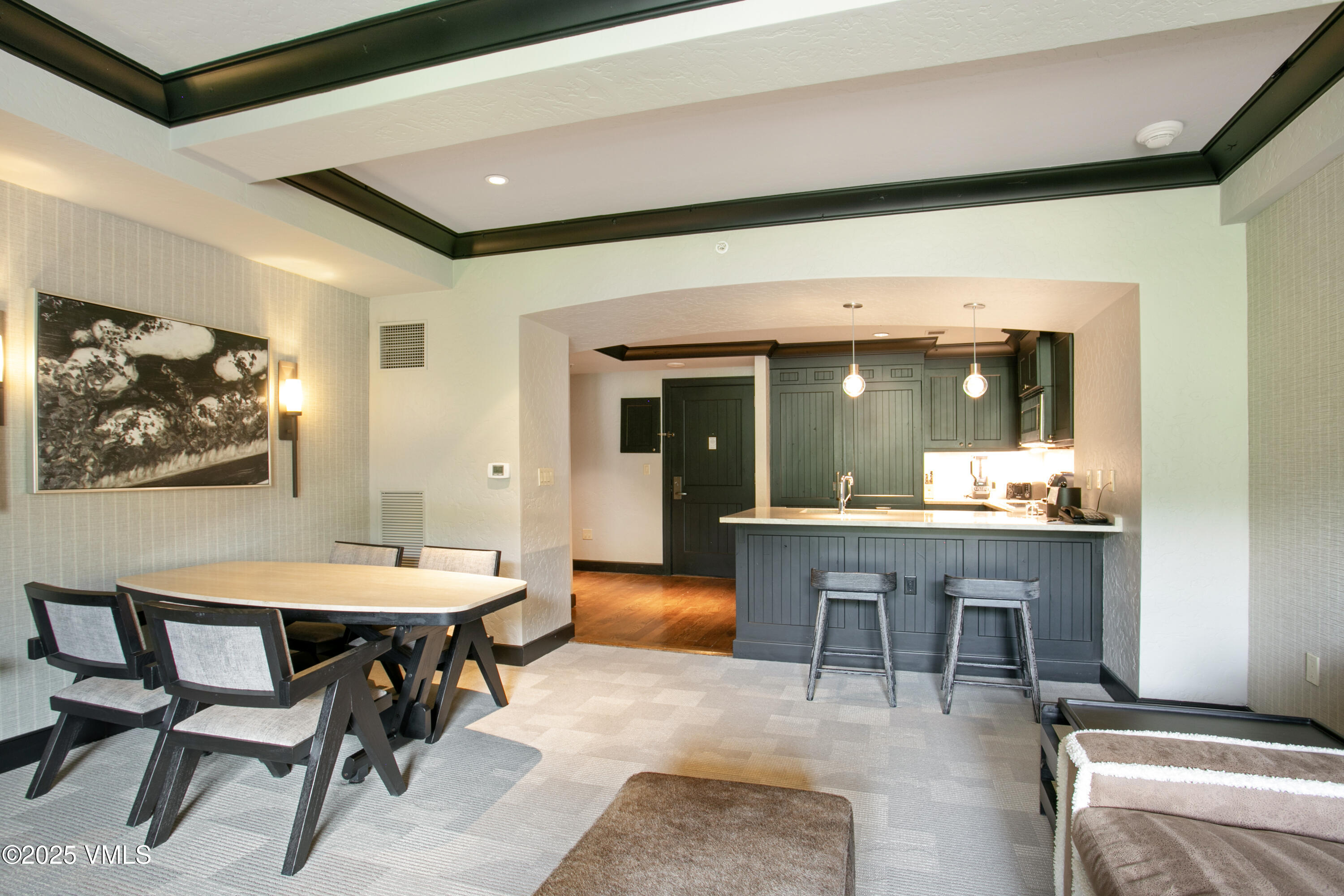 130 Daybreak Ridge Road, Unit 732 Avon, CO 81620 - Photo 6 of 17 a dining hall with stainless steel appliances kitchen island granite countertop a table chairs and a sink