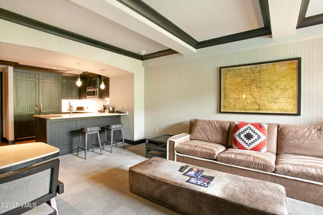 a living room with furniture and painting on the wall