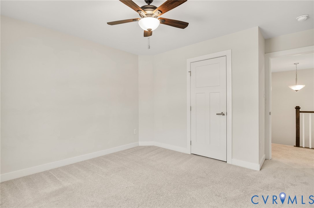8601 Forge Gate Lane Chesterfield, VA 23832 - Photo 24 of 37 an empty room with closet and a chandelier fan