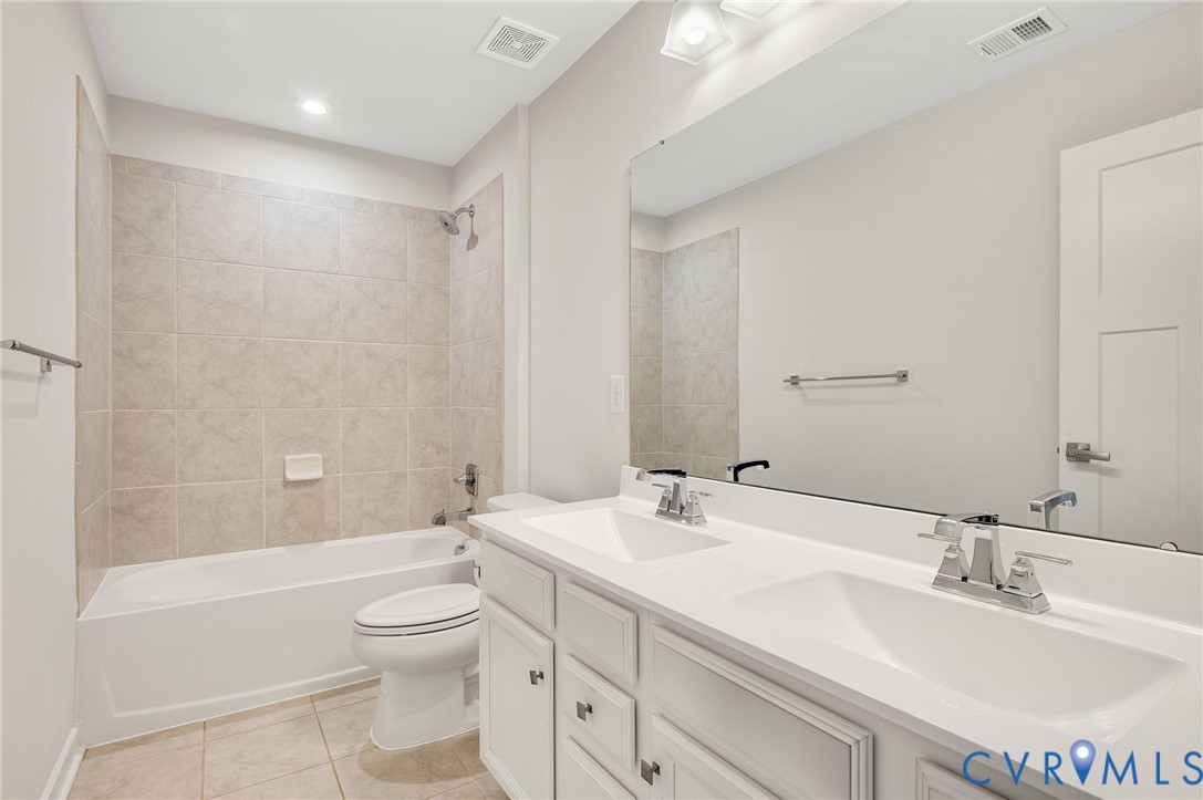 8601 Forge Gate Lane Chesterfield, VA 23832 - Photo 29 of 42 a bathroom with a double vanity sink toilet mirror and bathtub