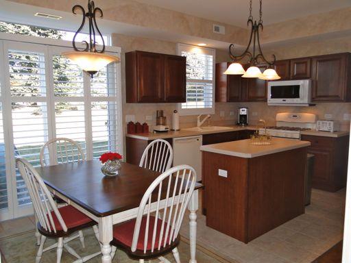 13384 Delaney Road Huntley, IL 60142 - Photo 9 of 16 a kitchen with a sink a counter space dining table and chairs