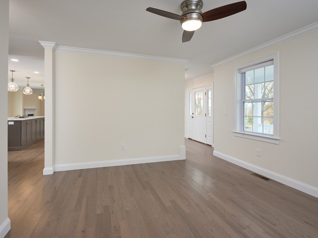 795 Leominster Road Lunenburg, MA 01462 - Photo 12 of 33 an empty room with wooden floor a ceiling fan and windows