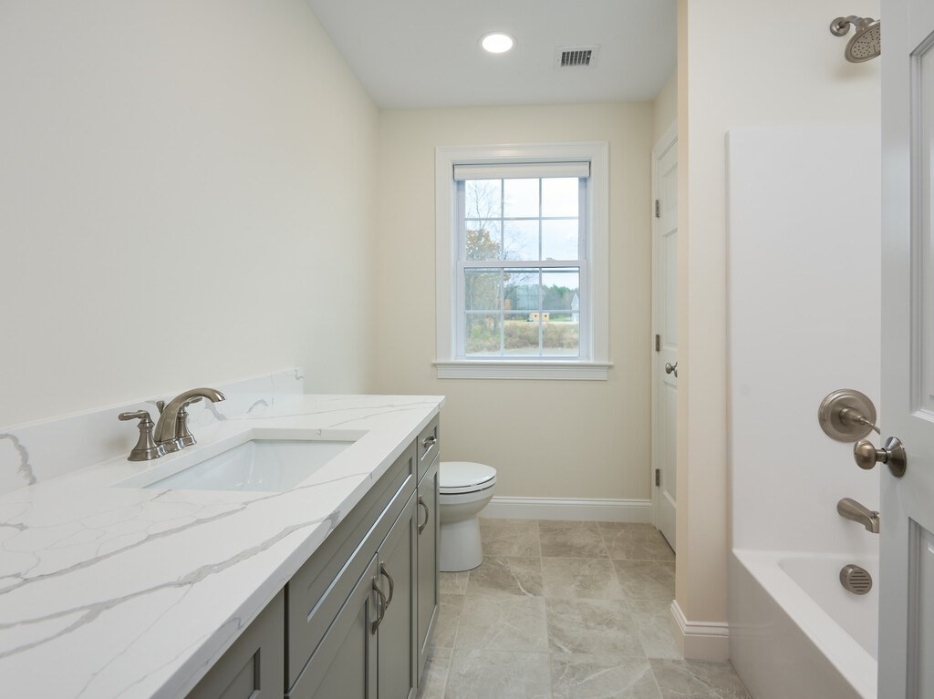 795 Leominster Road Lunenburg, MA 01462 - Photo 22 of 33 a bathroom with a sink a toilet and shower