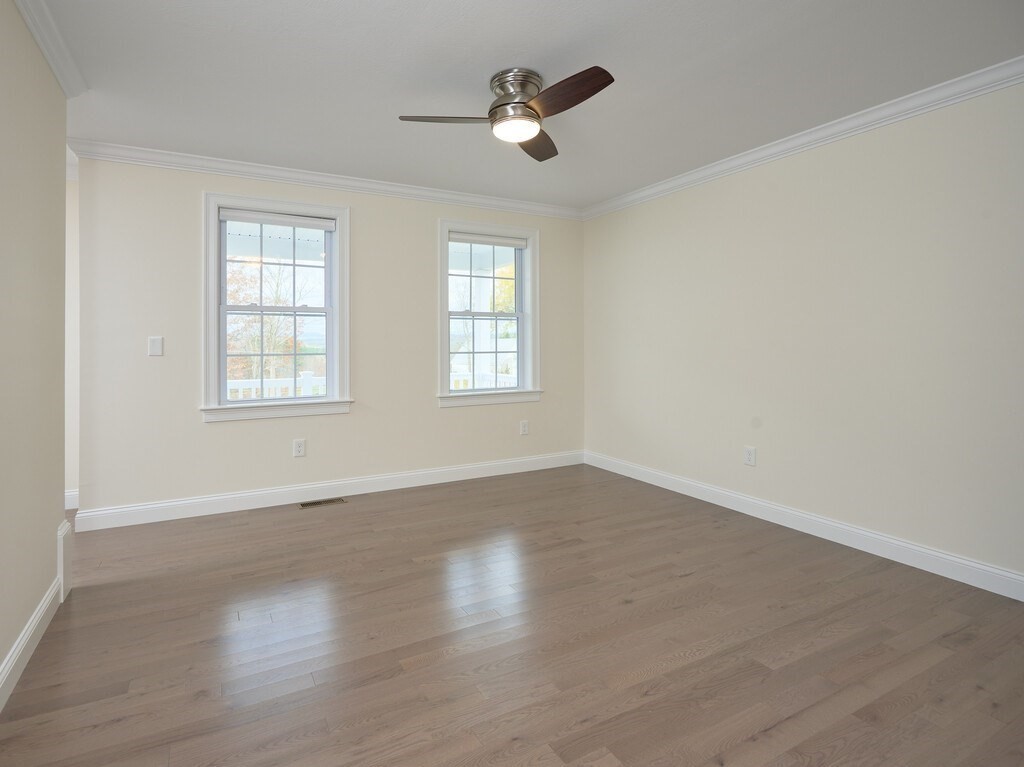 795 Leominster Road Lunenburg, MA 01462 - Photo 28 of 33 an empty room with wooden floor and windows
