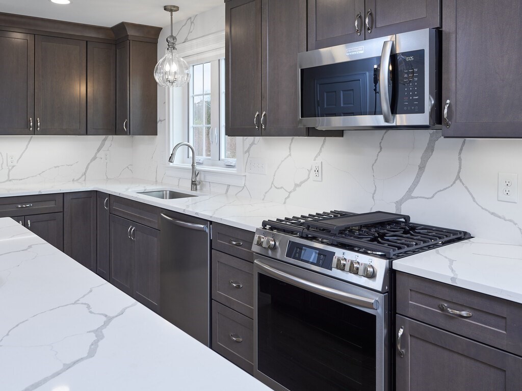 795 Leominster Road Lunenburg, MA 01462 - Photo 3 of 33 a kitchen with stainless steel appliances a stove a sink and a microwave